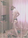 A girl in panties - thru the window