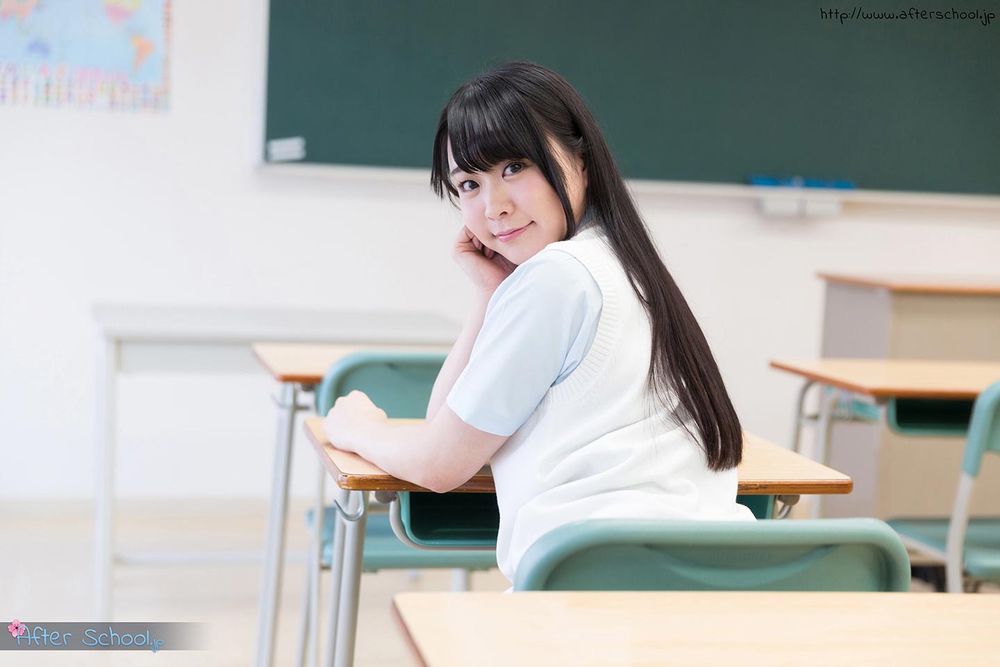 Beautiful schoolgirl posing in the classroom